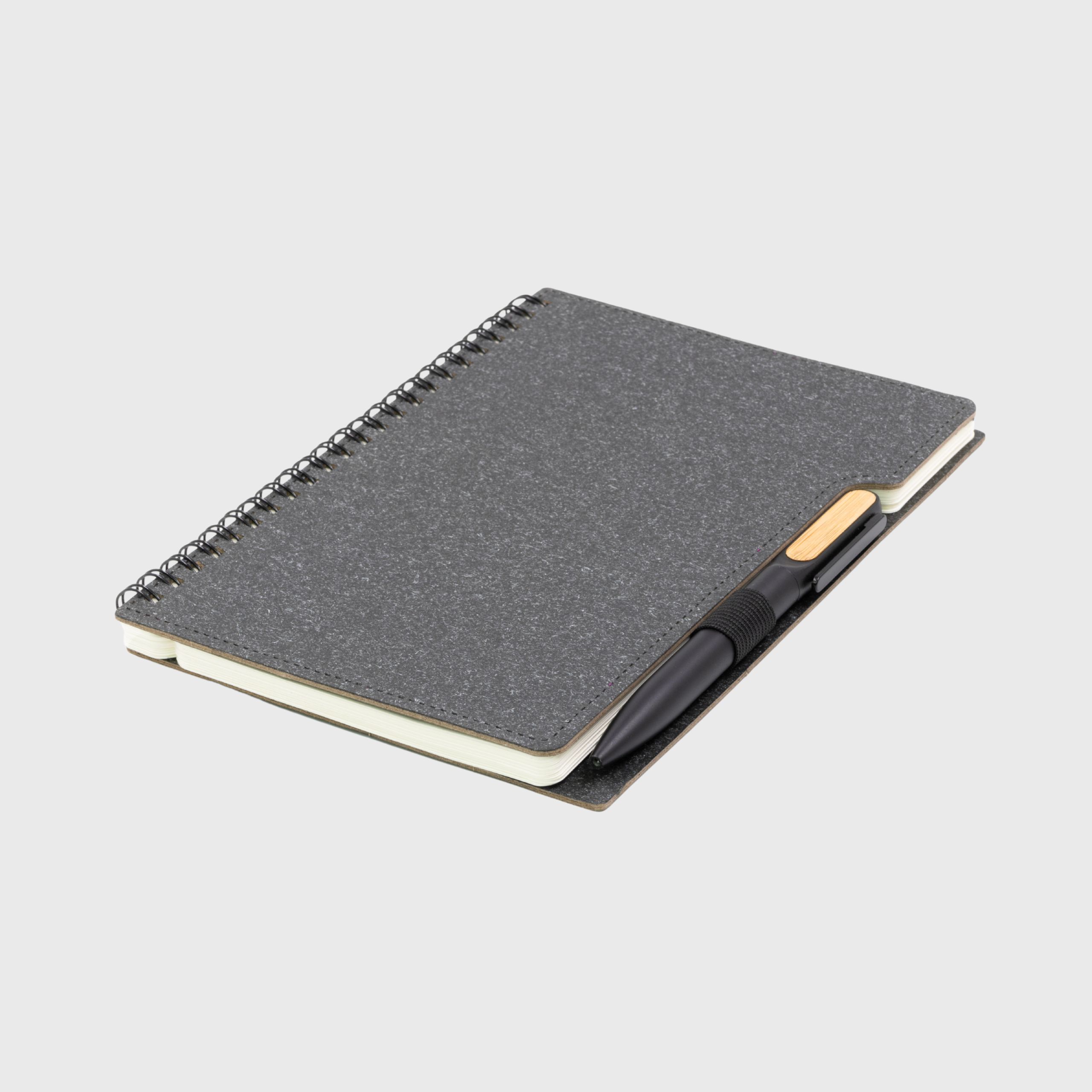 A5 Sustainable Eco Spiral Hardcover Notebook Made From Recycled Paper paired with bamboo pen